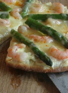 spring pizza with shrimp imp asparagus cheese and garlic scapes